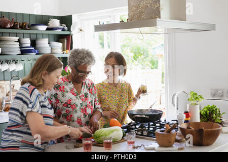 Active senior women cooking in kitchen Stock Photo
