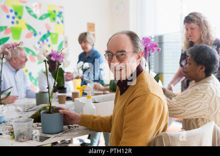 Portrait smiling, confident active senior man enjoying flower arranging class Stock Photo