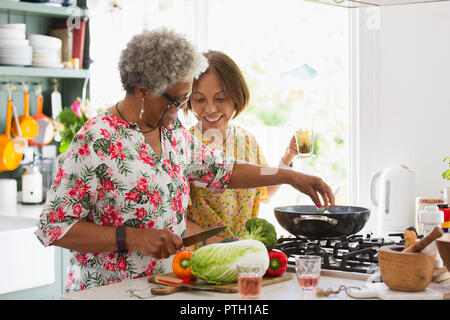 Active senior women cooking in kitchen Stock Photo