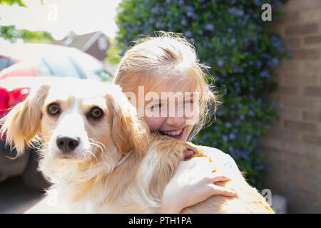 Happy girl hugging dog Stock Photo