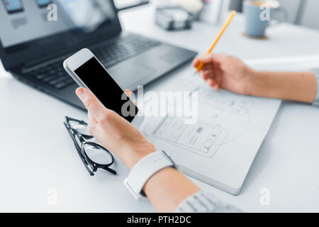 web designer working on smartphone user interface Stock Photo