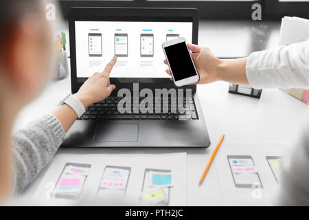 web designers work on smartphone user interface Stock Photo