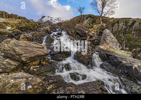 Idwal Falls on the path from Idwal Cottage by Llyn Ogwen up to Llyn Idwall with the summit of Y Garn in the background Snowdonia North Wales UK Februa Stock Photo