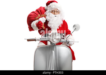 Santa Claus on a scooter with a bag of presents isolated on white background Stock Photo