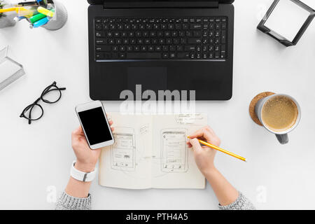 web designer working on smartphone user interface Stock Photo