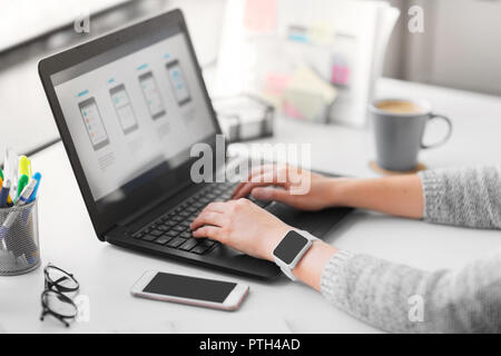 web designer with laptop working on user interface Stock Photo