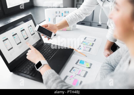 web designers work on smartphone user interface Stock Photo