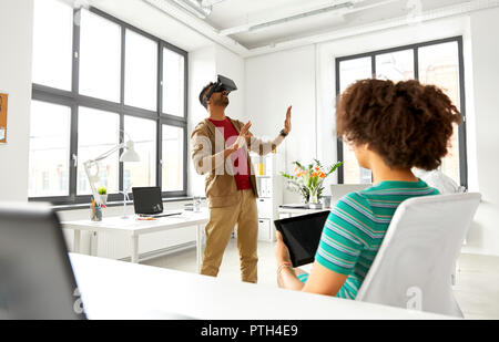 developers with virtual reality headset at office Stock Photo