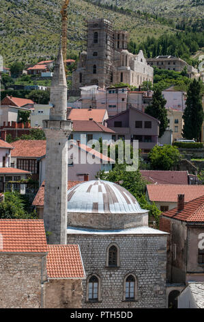 Mostar: the Clock Tower (Sahat Kula), example of the proliﬁc Ottoman period, bombed during the Bosnian War (1992-1995), and a mosque with its minaret Stock Photo