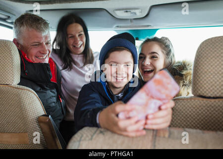 Happy family with smart phone in motor home Stock Photo