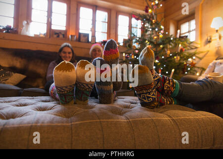 Family with colorful socks relaxing in Christmas living room Stock Photo