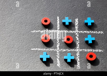 Close up picture of tic tac toe game (noughts and crosses) on dark background, selective focus. Stock Photo