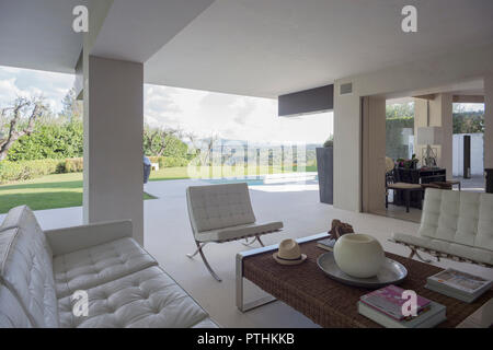 Private swimming pool in front an apartment with benches and deck chairs Stock Photo