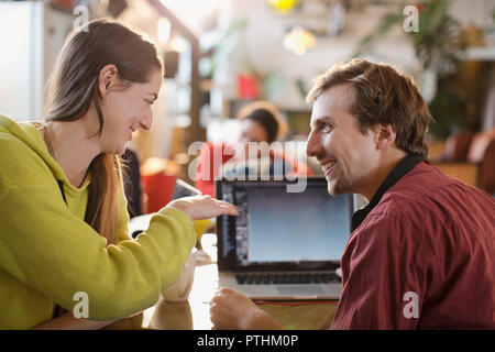 Couple using laptop at table Stock Photo
