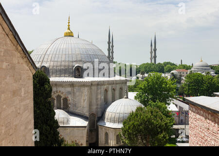 View of the exterior domed buildings that surround the Hagia Sophia museum, the minarets of the Blue Mosque can be seen in the background, Istanbul, T Stock Photo