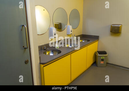 washroom with wash basins and mirrors in a public toilet or lavatory Stock Photo