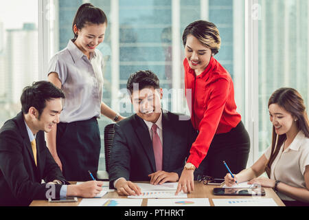 Group of businesspeople sharing their smart business ideas in the office Stock Photo