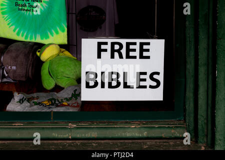 JOHNSON CITY, TN, USA-9/30/18: Store window with a sign offering free Bibles. Stock Photo