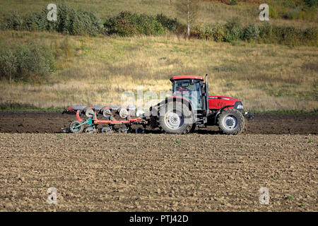 Salo, Finland - September 29, 2018: Farmer plows field with Case IH Maxxum 140 tractor and plough on sunny day of autumn in South of Finland. Stock Photo