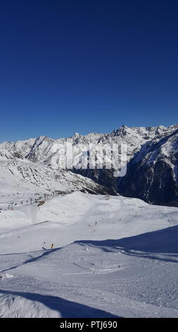Image of ski resort in the winter with snow covered mountains and well prepared slops Stock Photo