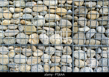 Stone walls in a metal grid. The design of the Mall Parking lot.