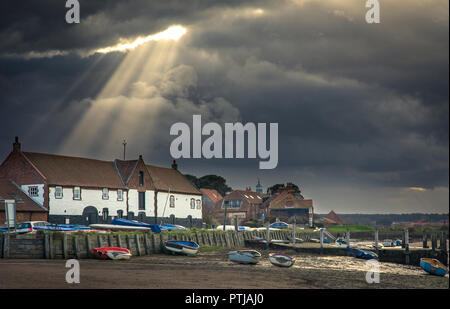 God beams or crepuscular rays at Burnham Overy Staithe. Stock Photo