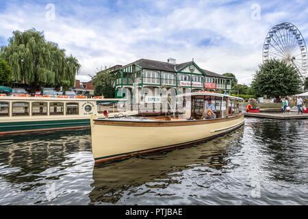A river tour boat in front of the boathouse on the river Avon. Stock Photo