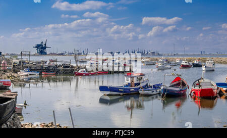 Small fishing boats in Paddys Hole on South Gare with the industrial north bank of the Tees behind. Stock Photo