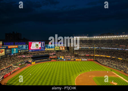 A baseball match between the local Yankees and the Cleveland Indians is underway in a packed Yankee Stadium in the Bronx. Stock Photo