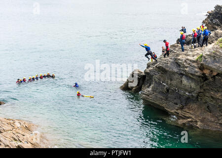 Holidaymakers coasteering on The Headland in Newquay in Cornwall. Stock Photo