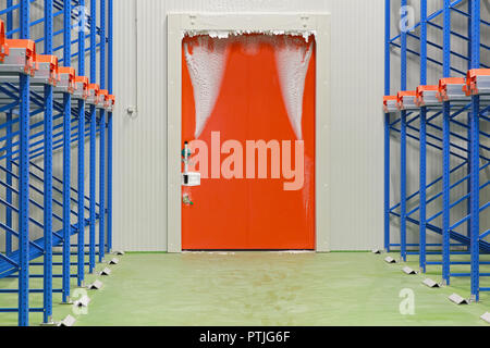 Warehouse freezer door covered in ice and frost Stock Photo