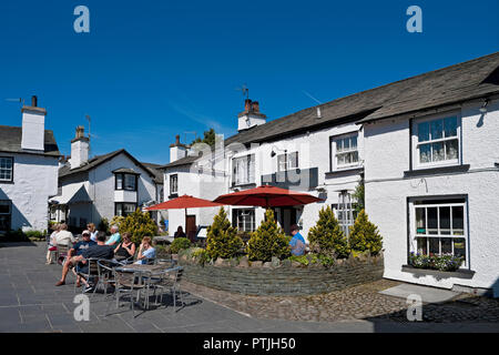 People relaxing outside the Kings Arms Inn in Hawkshead village. Stock Photo