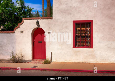 Red door and window frame of an artisan style house in Old Town Tucson City, AZ Stock Photo