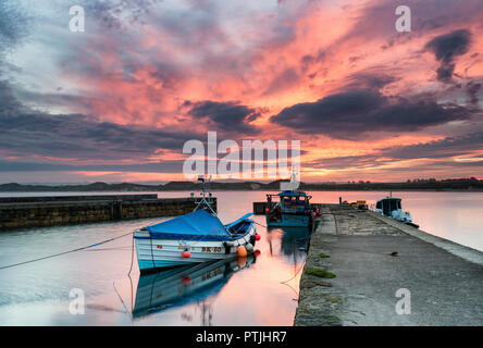 A spectacular sunset over Beadnell harbour. Stock Photo