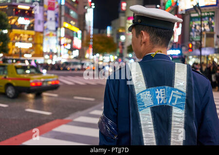 Japanese policeman at the Shibuya crossing in Tokyo. Stock Photo