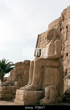 A damaged, literally defaced, statue of Pharaoh Ramses II at Karnak Temple, Luxor, Egypt. Stock Photo