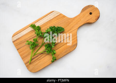 Parsley Sprigs on a Cutting Board Stock Photo