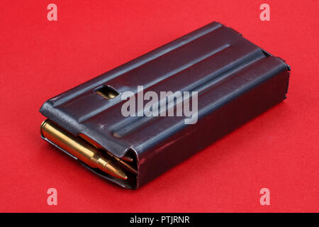 US ARMY M16 Rifle 20rd Magazine Vietnam war period with ammo on red background Stock Photo