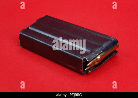 US ARMY M16 Rifle 20rd Magazine Vietnam war period with ammo on red background Stock Photo