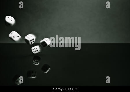 Thrown dice blurred by movement, reflective surface Stock Photo