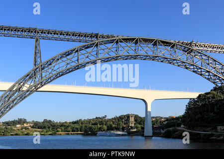 Old iron Maria Pia and new concrete Sao Joao bridges over Douro river, Porto, Portugal Stock Photo