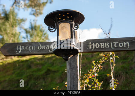 Matamata, New Zealand: Hobbiton movie set created to film Lord of the Rings and The Hobbit. Signpost and lantern marks a route.