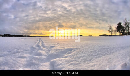 Deep snow on frozen sea in the north. Beautiful cold winter morning sunrise HDR. Stock Photo