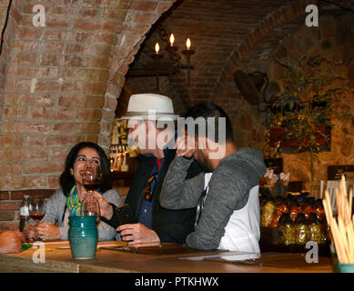 Tourists sample wines in the tasting room at Castello di Amorosa winery, housed in a reproduction 13-century medieval Italian stone castle in Calistog Stock Photo