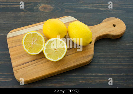 Slicing Lemons on a Wood Cutting Board Stock Photo