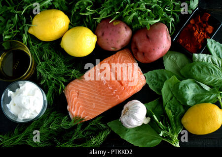 Baked Lemon Salmon and Potatoes with Dill Yogurt Ingredients Stock Photo
