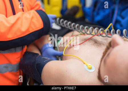 Emergency doctor checking blood pressure of a patient in the ambulance Stock Photo