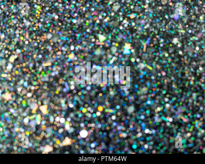 Beautiful dot bokeh. Blurred Holographic glitter on black background. Abstract art multicolor glitter bokeh background. Stock Photo
