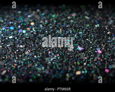 Holographic glitter on black background. Abstract art multicolor glitter background. Stock Photo