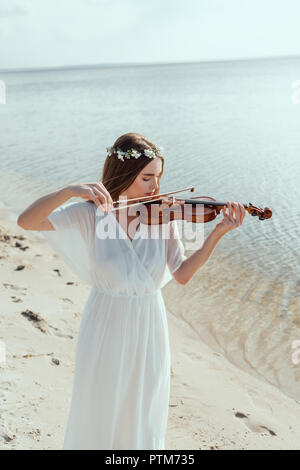 https://l450v.alamy.com/450v/ptm735/beautiful-woman-in-elegant-white-dress-and-floral-wreath-playing-violin-on-seashore-ptm735.jpg